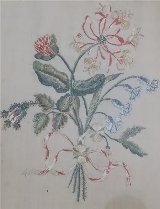 A pair of Regency silkwork panels of floral sprays, eglomise framed